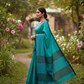 Turquoise handwoven cotton saree walking in nature