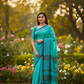Turquoise teal checked cotton saree with navy border in garden